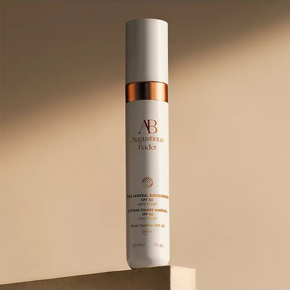 A bottle of Augustinus Bader sunscreen. Summer beauty, sun protection.