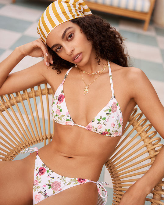 A woman in a bikini with floral print. Shop swim.