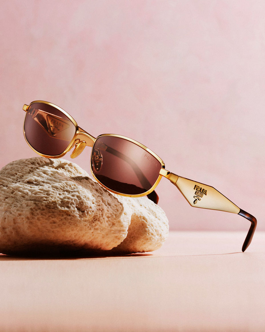 A pair of sunglasses resting on a stone. Summers most wanted, sunglasses.