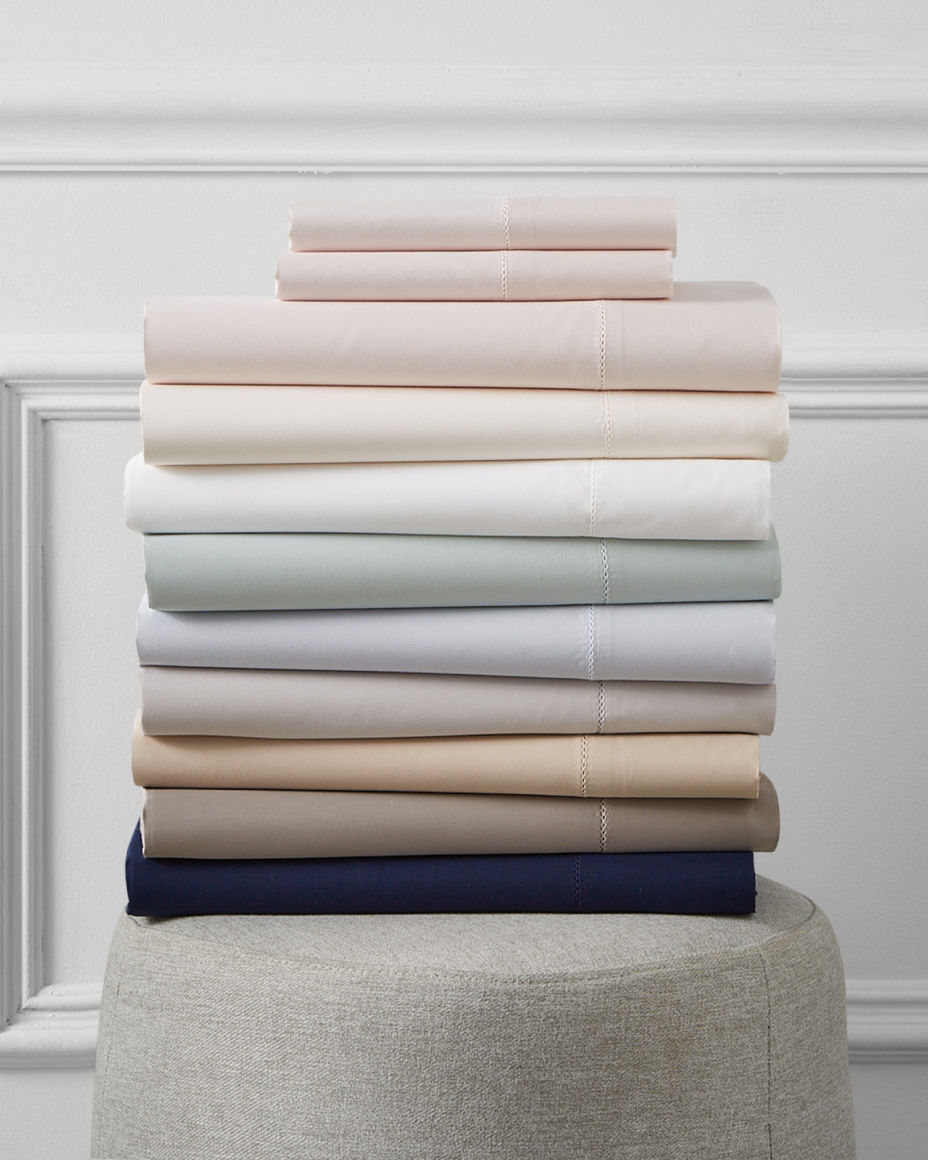 A folded stack of muted color sheets. Top picks for the new year, dorm.