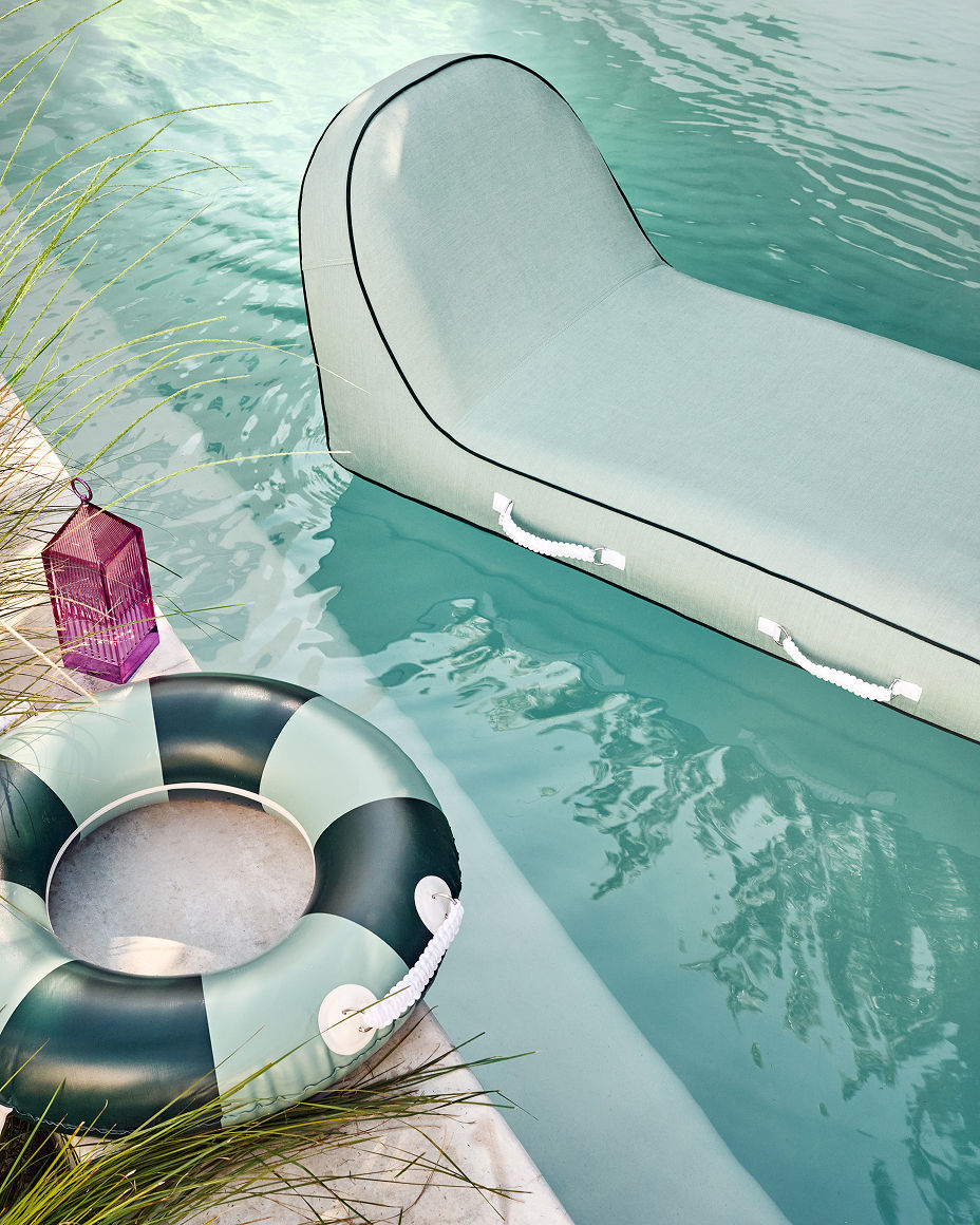 A pool lounger next to a pool float. Featured shops, outdoor living.