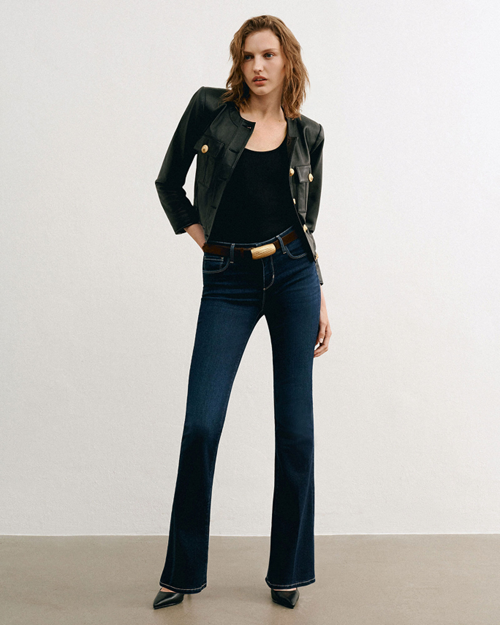 A woman in dark L Agence jeans, black top & jacket. Denim labels we love, L Agence.