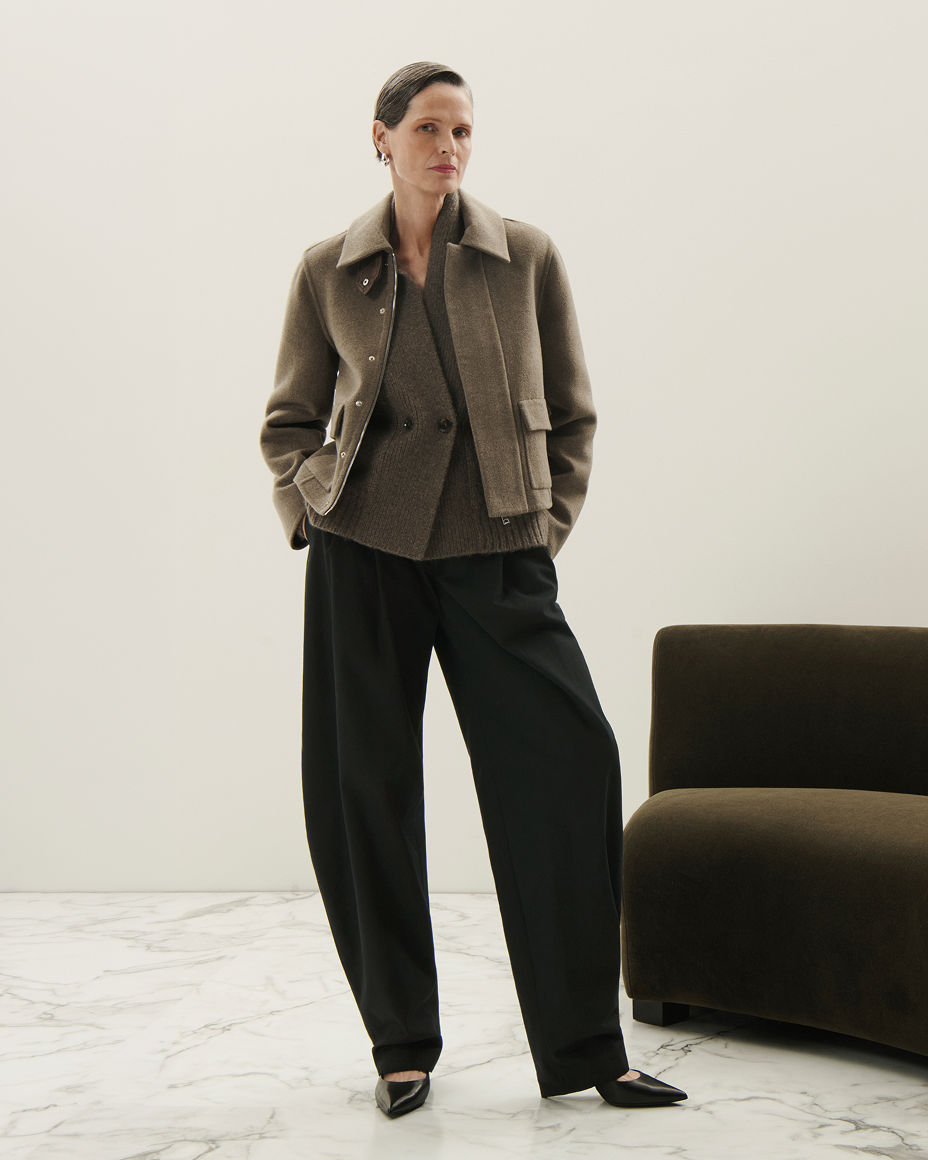 A woman in a Brandon Maxwell army green jacket over a double breasted top & pants. The fall collections, Brandon Maxwell.