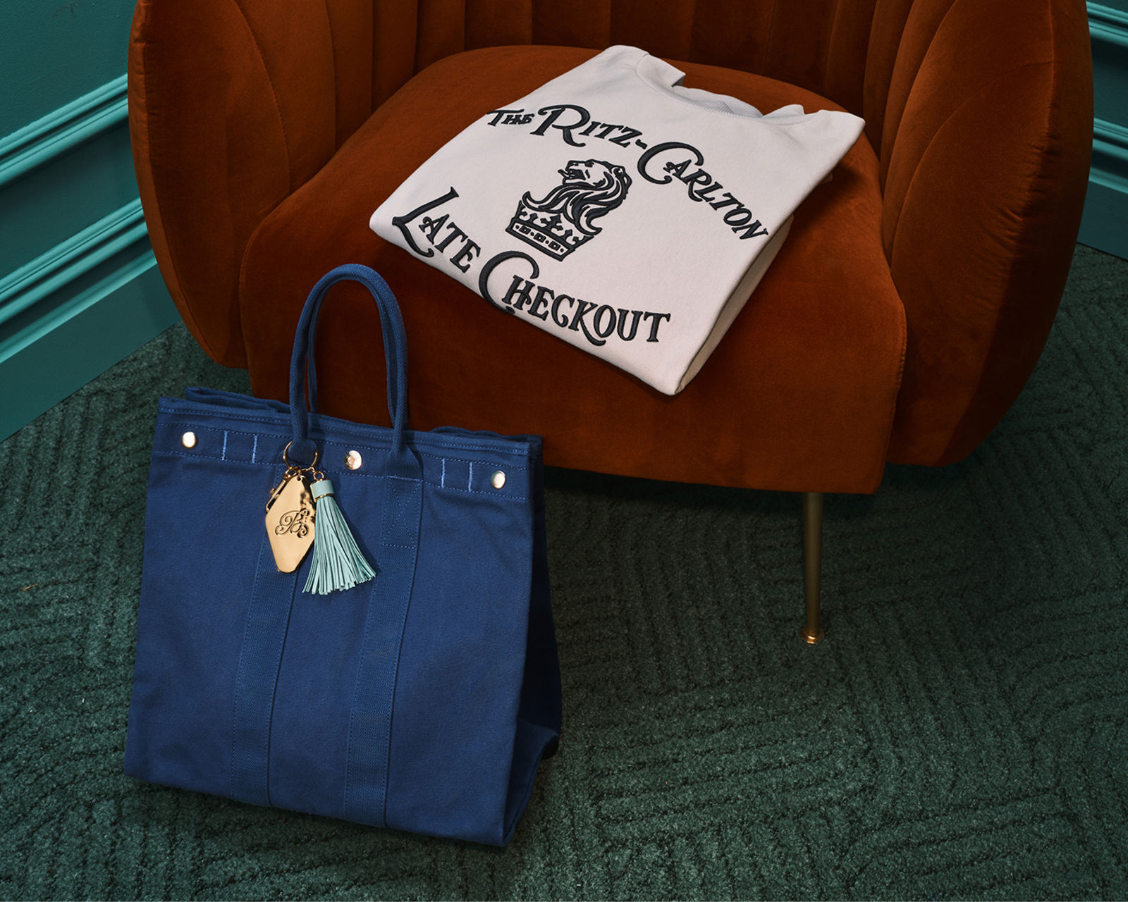 A blue Alex Mill tote & The Ritz Carlton and Late Checkout crewneck. Hotel Bloomingdales, the gift shop.