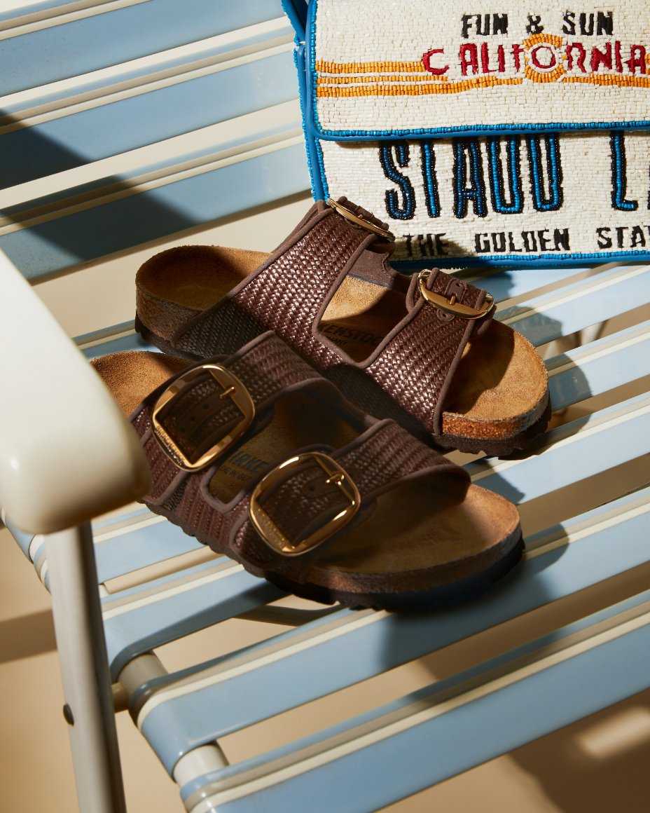 A pair of brown Birkenstock plus Staud sandals and a Cali inspired Tommy bag.