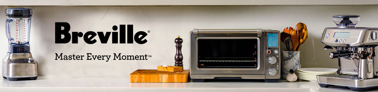 Breville. Master every moment. A Breville blender, toaster oven, and coffee maker on a marble countertop.