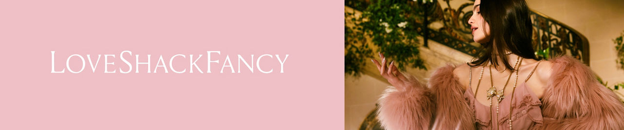 Love Shack Fancy. A woman in a pink feather top Love Shack Fancy jacket over a pink dress.