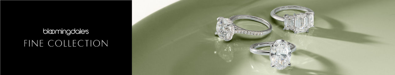 1 photo, of 3 sparkling diamond solitaire rings with white gold bands, in baguette, round, and oval cuts, on a shiny green surface.