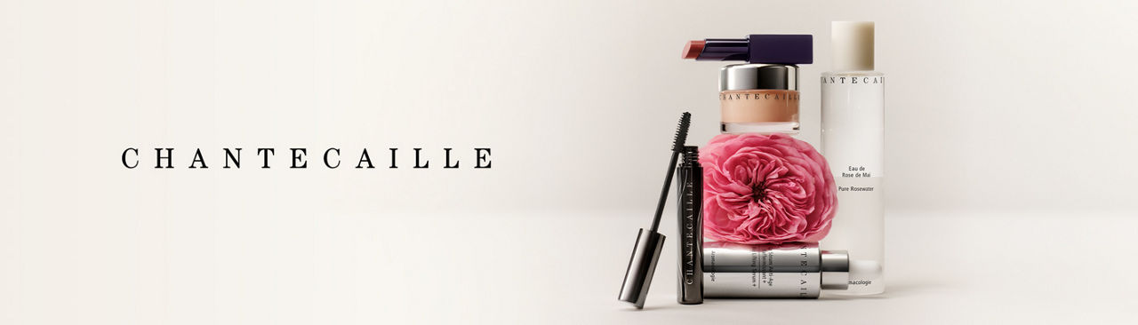 1 photo, of various Chantecaille beauty and skincare products, including an open tube of mascara and lipstick, arranged around a pink flower.